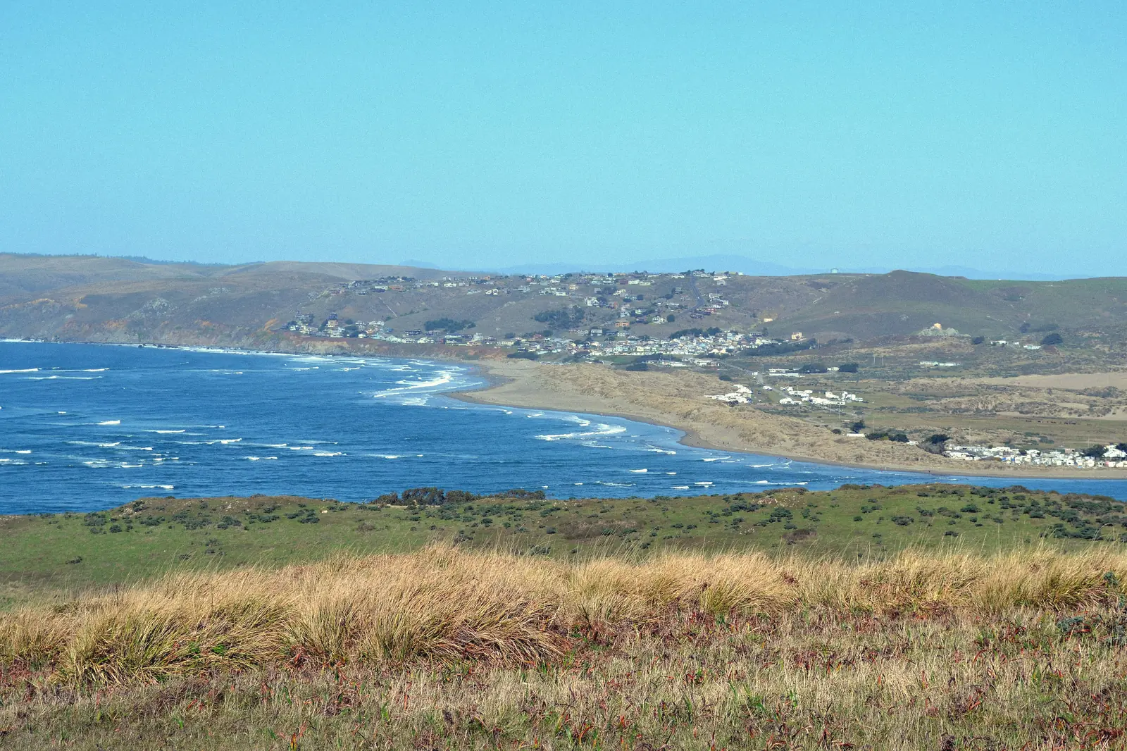 Photo of blue water and green hills at Tomales Bay